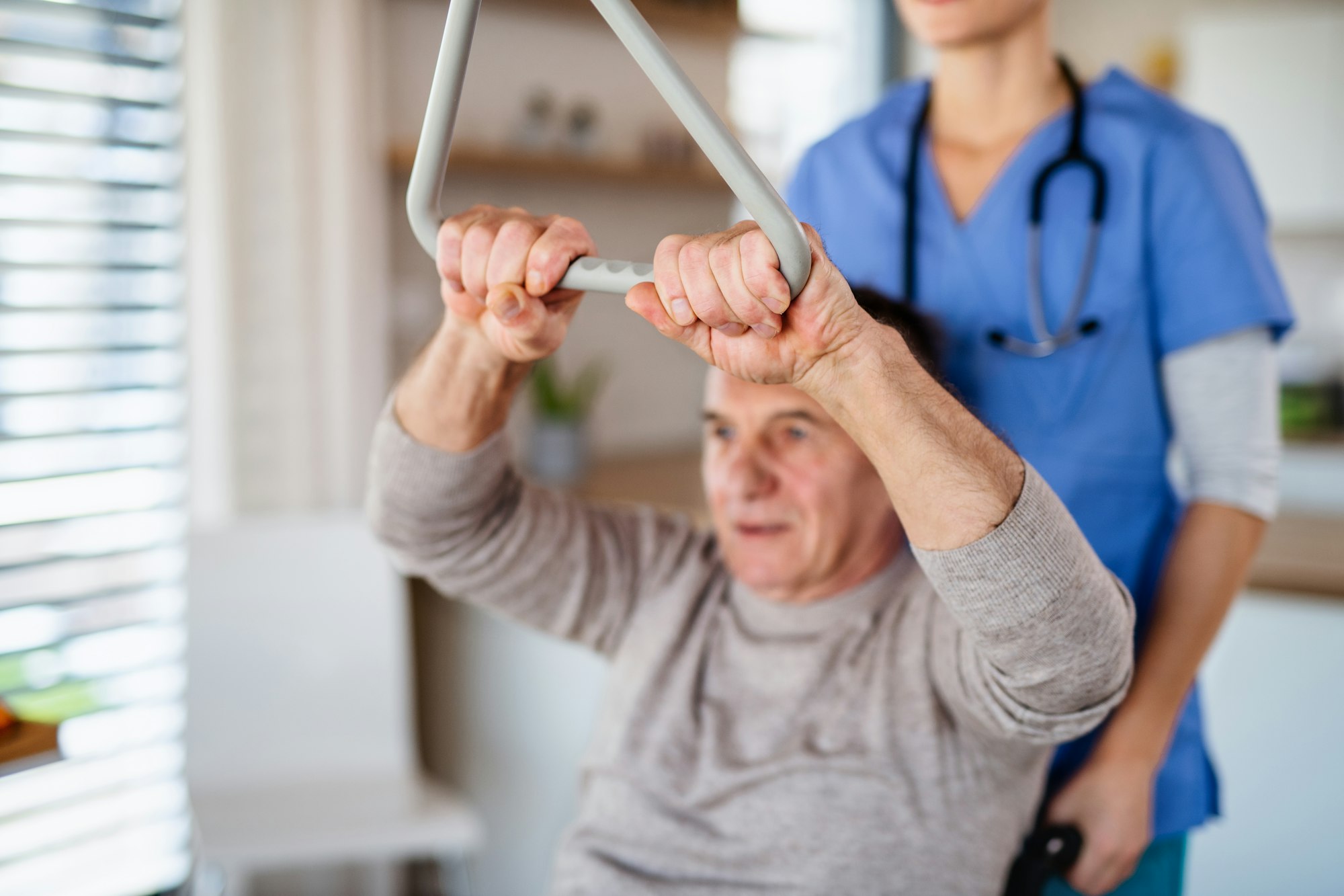 A healthcare worker and senior patient in hospital, physiotherapy.