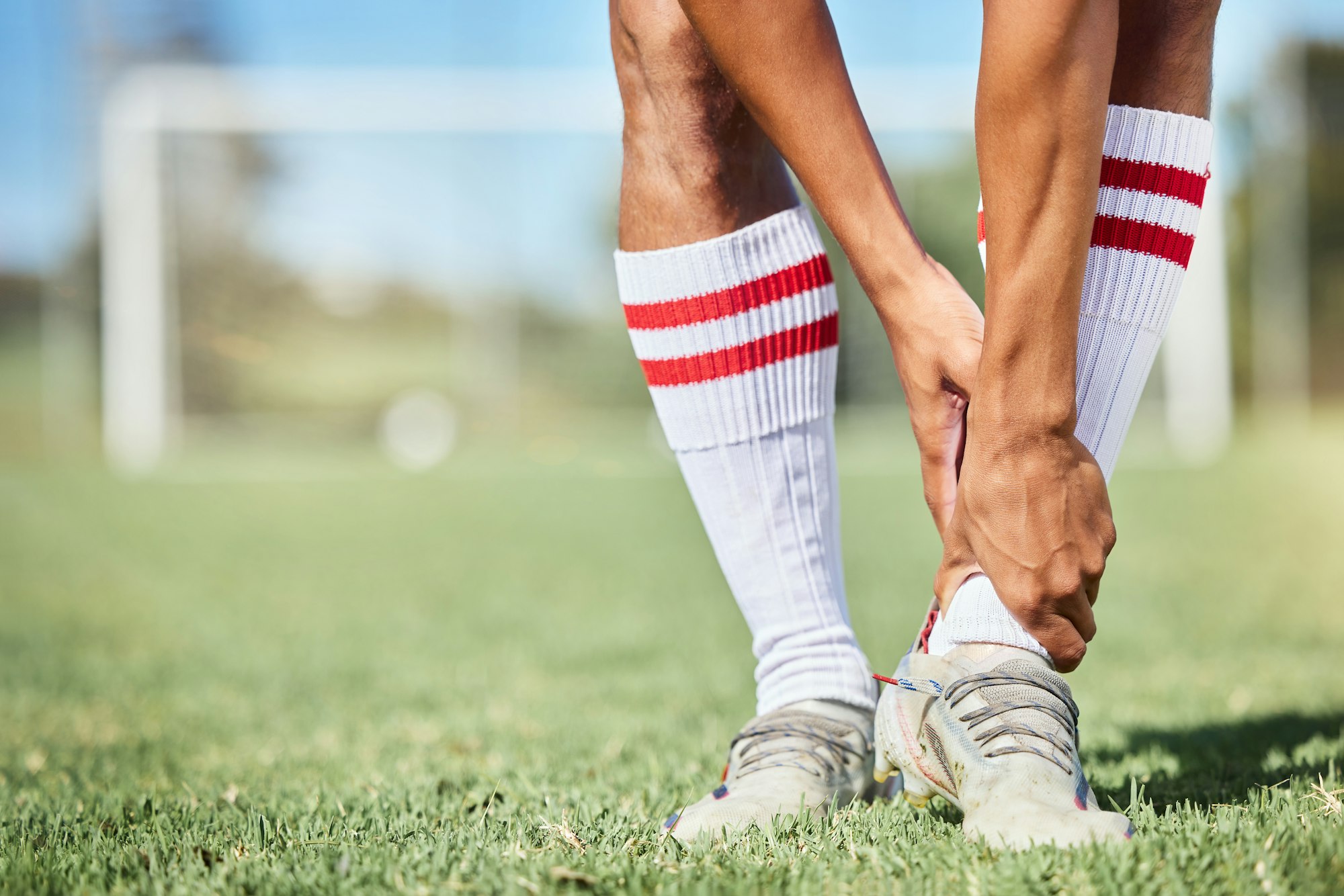 Soccer, sports and ankle pain, injury or accident on a field during a game, exercise or training. M